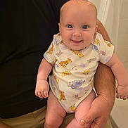 Laken joined the competition — help win amazing prizes! baby, infant, smile, happy, onesie, winnie_the_pooh, child, person, adult_hand, holding, indoor, clothing, cute, skin, face, expression, human, arm, leg, babywear