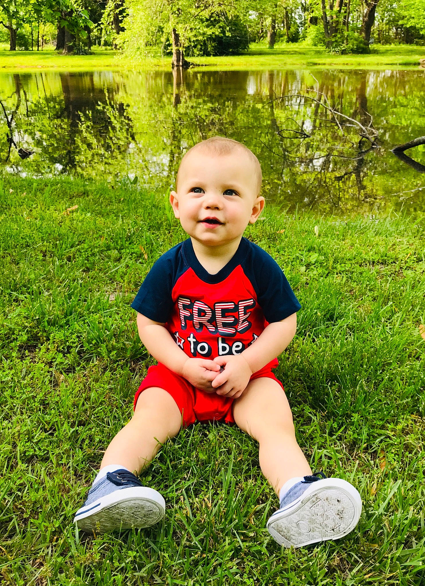 Kai is registered to the contest to win money with this photo: child, cool, fun, grass, grass_family, green, happy, joy, lawn, leisure, meadow, people_in_nature, person, photograph, photography, play, red, sitting, smile, spring