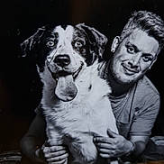 Akamaru participe au concours pour gagner de l'argent avec cette photo : dog, man, black_and_white, portrait, smiling, pet, tongue_out, happy, friendship, indoor, person, animal, cute, fur, face, holding, closeup, eyes, nose, casual_clothing