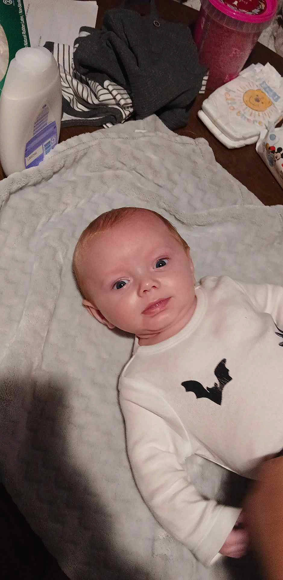 Charlie is registered to the contest to win money with this photo: baby, baby_products, baby_safety, baby_toddler_clothing, cheek, child, comfort, fur, iris, linens, nose, person, room, sitting, sleeve, smile, toddler