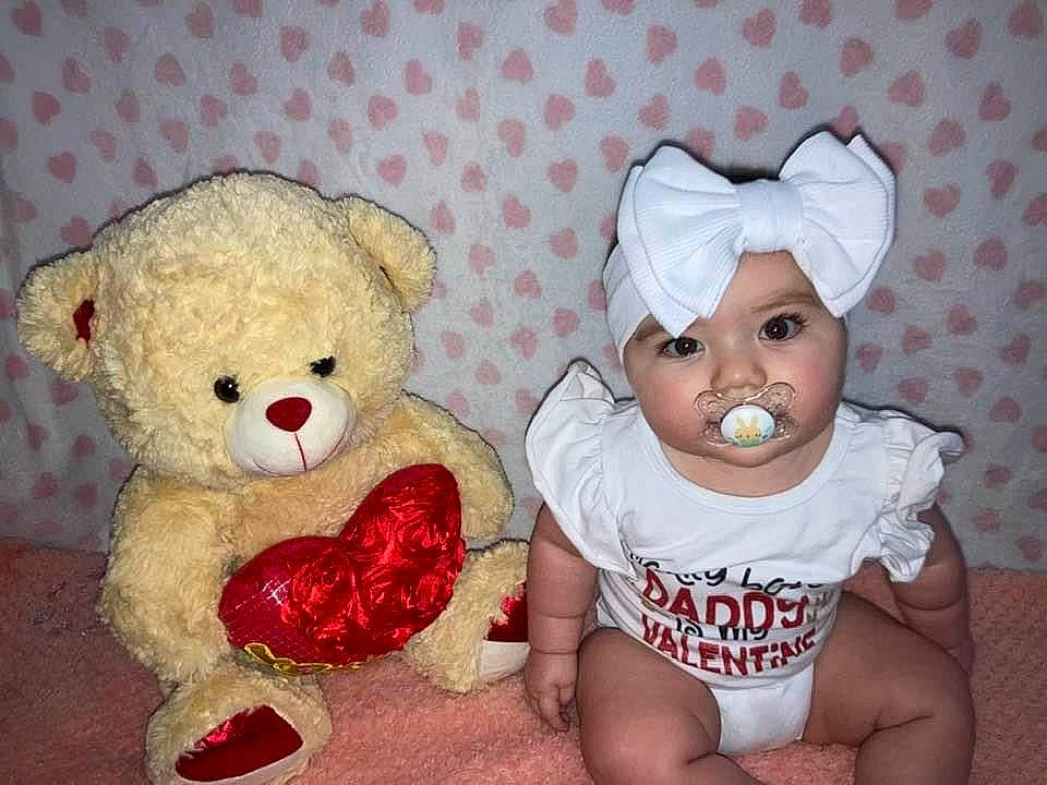 Arielle joined the competition — help win amazing prizes! baby, baby_sleeping, baby_toddler_clothing, cheek, child, comfort, eye, happy, head, headwear, human_body, mammal, nose, person, pink, red, stuffed_toy, teddy_bear, textile, toddler