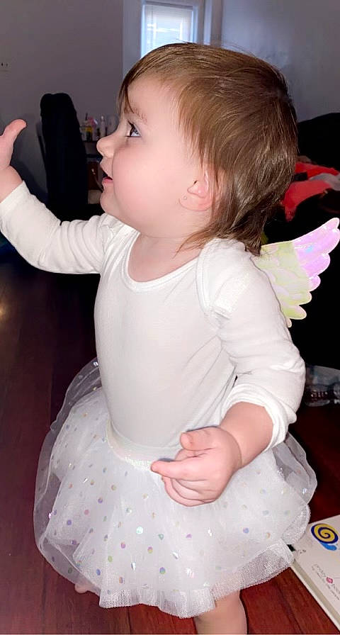 Arielle is registered to the contest to win money with this photo: arm, baby_toddler_clothing, cheek, child, dress, ear, eye, finger, gesture, hair, hairstyle, hand, head, iris, neck, person, pink, shoulder, skin, sleeve