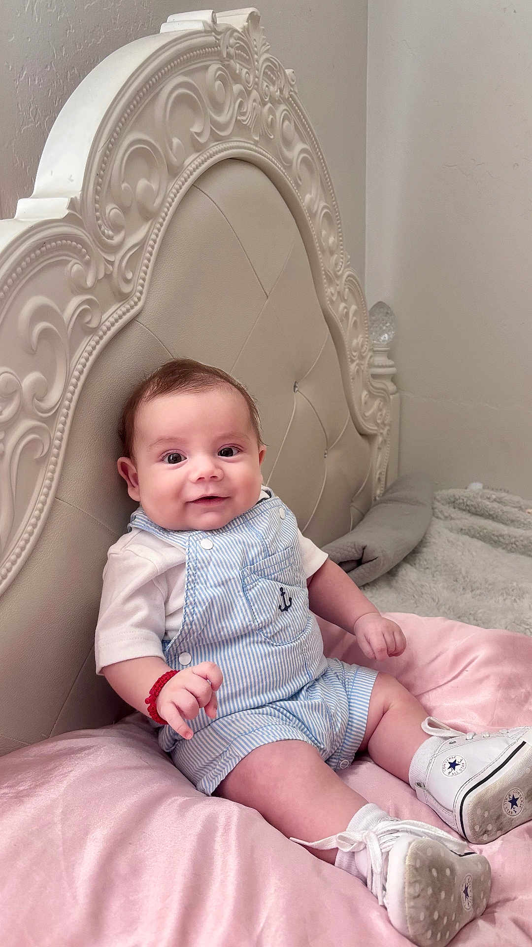Ariel joined the competition — help win amazing prizes! baby, infant, smiling, overalls, sneakers, bed, headboard, blanket, pink, white, blue, bracelet, cute, indoor, portrait, child, happy, clothing, furniture, soft