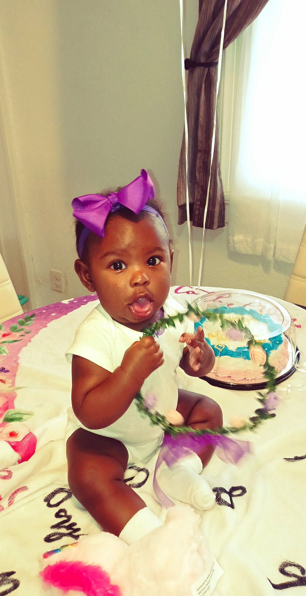 Dakota is registered to the contest to win money with this photo: baby, baby_toddler_clothing, baked_goods, birthday, birthday_cake, cake, cake_decorating, cake_decorating_supply, event, food, happy, headpiece, magenta, party_supply, person, petal, pink, purple, sugar_cake, sugar_paste