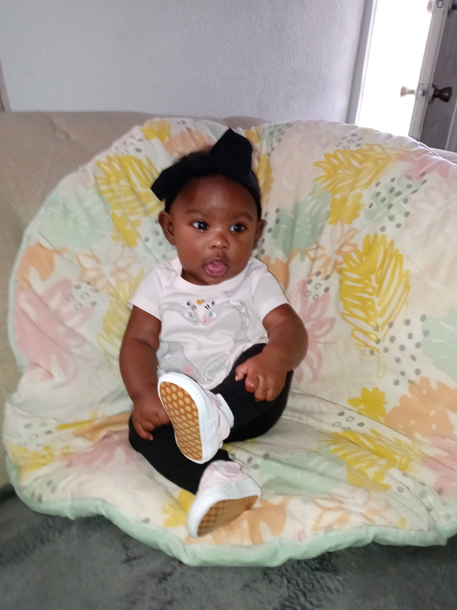 Dakota is registered to the contest to win money with this photo: baby, baby_products, baby_toddler_clothing, child, comfort, couch, face, fun, happy, linens, person, pink, room, shirt, shorts, sitting, sock, t_shirt, textile, thigh