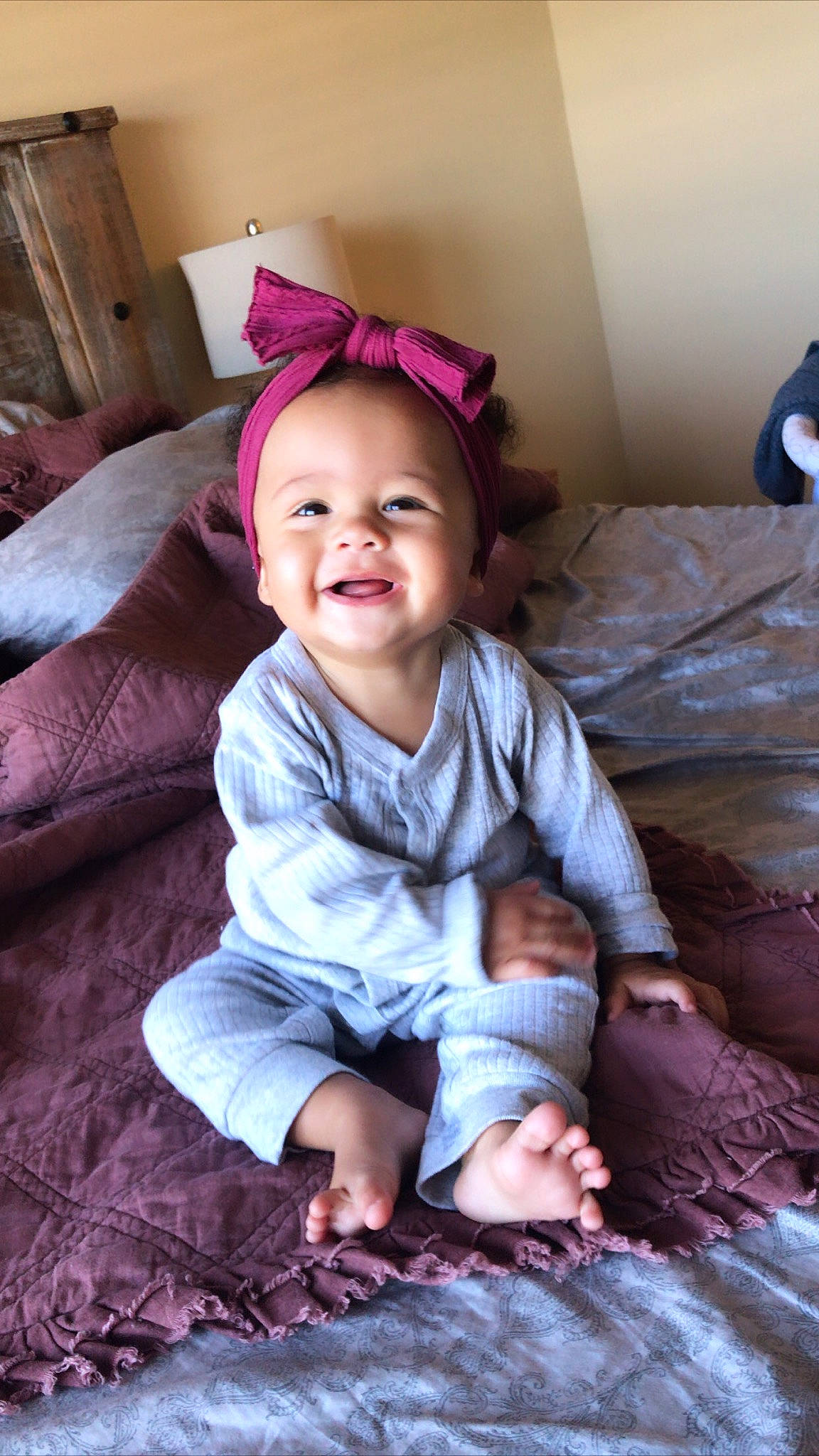 Remi is registered to the contest to win money with this photo: baby, baby_toddler_clothing, comfort, couch, eye, facial_expression, floor, flooring, hairstyle, happy, head, iris, joy, mouth, person, pink, purple, skin, smile, standing