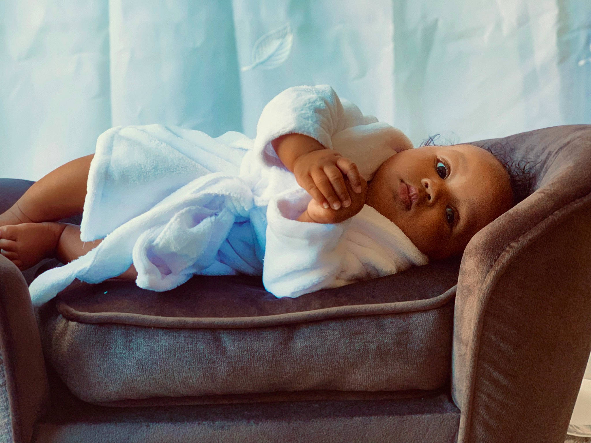 Malaysia is registered to the contest to win money with this photo: baby, baby_sleeping, bedding, bedtime, child, comfort, couch, eye, hat, head, joint, knee, linens, nap, person, portrait_photography, room, sitting, sleep, textile