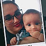 woman, baby, glasses, holding, toy, hand, face, portrait, smile, indoor, closeup, child, person, cute, family, polaroid, photo_frame, expressive, casual, happy