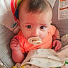 Xavier is registered to the contest to win money with this photo: baby, infant, pacifier, blanket, toy, colorful, monkey, sun, baby_seat, clothing, cute, child, looking_up, soft_toy, pattern, fabric, playtime, comfort, happy, portrait