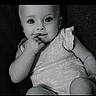 Anna joined the competition — help win amazing prizes! baby, child, infant, portrait, black_and_white, sitting, chair, indoors, face, eyes, smile, curious, finger, dress, short_sleeves, close_up, photograph, monochrome, vintage_style, happy