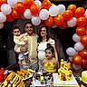 family, celebration, birthday, child, baby, cake, balloons, food, table, party, people, smiling, indoor, decorations, bread, father, mother, daughter, festive, colorful
