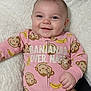 Kaylee is registered to the contest to win money with this photo: baby, smiling, infant, onesie, pink_clothing, monkey_pattern, banana_pattern, blanket, soft_texture, cute, child, happy, portrait, lying_down, indoors, cozy, sleepwear, face, small_hand, playful