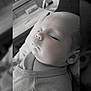 baby, black_and_white, calm, child, closeup, clothing, cozy, cute, face, head, indoors, infant, newborn, peaceful, person, portrait, resting, sleeping, soft_light, toddler