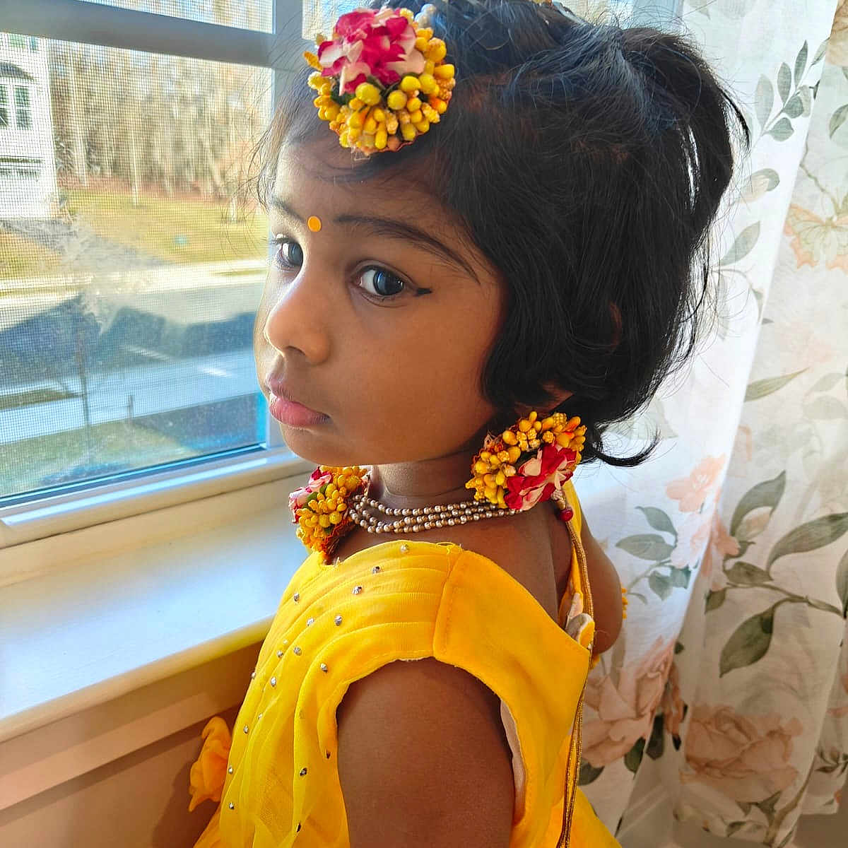 Thanmathi joined the competition — help win amazing prizes! arm, black_hair, child, curtain, decor, face, floral_jewelry, flower_accessories, girl, home, indoor, looking_away, natural_light, necklace, pensive, portrait, traditional_clothing, window, yellow_dress, young_child