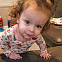 toddler, child, pajamas, indoor, curly_hair, face, couch, toy, hand, window, living_room, smile, person, clothing, furniture, curiosity, home, young_child, baby, portrait