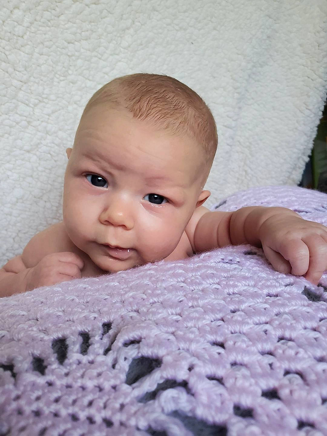 Emma Jayne is registered to the contest to win money with this photo: baby, beauty, bedding, blanket, cheek, child, close_up, eye, face, forehead, head, knitting, lip, nose, person, photograph, photography, skin, textile, toddler