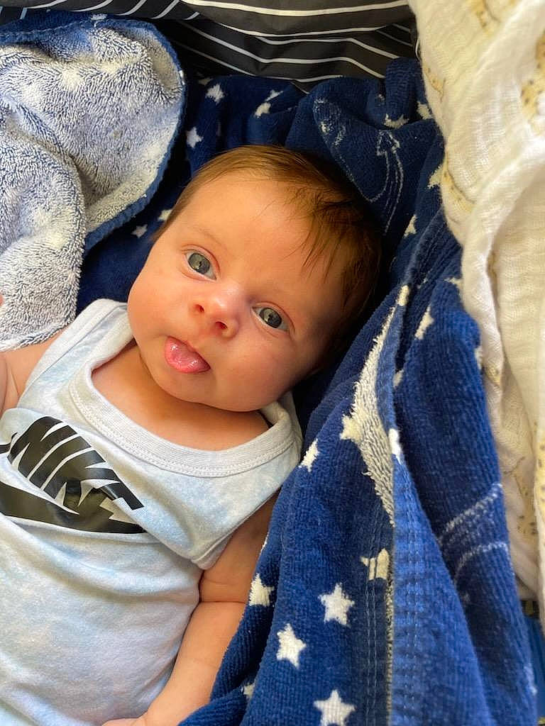 Lennon is registered to the contest to win money with this photo: baby, baby_carriage, baby_products, baby_toddler_clothing, cheek, child, comfort, electric_blue, eye, flash_photography, happy, iris, linens, outerwear, person, sitting, skin, sleeve, smile, textile