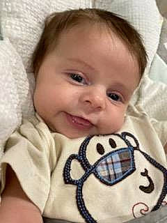 Lennon is registered to the contest to win money with this photo: baby, baby_toddler_clothing, cheek, chin, comfort, eye, eyebrow, facial_expression, happy, iris, lip, mammal, mouth, nose, organ, person, product, skin, sleeve, smile