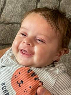 Lennon is registered to the contest to win money with this photo: baby, baby_toddler_clothing, cheek, child, collar, eyelash, fun, hair, happy, iris, lip, mouth, nose, pattern, people, person, plaid, skin, sleeve, smile