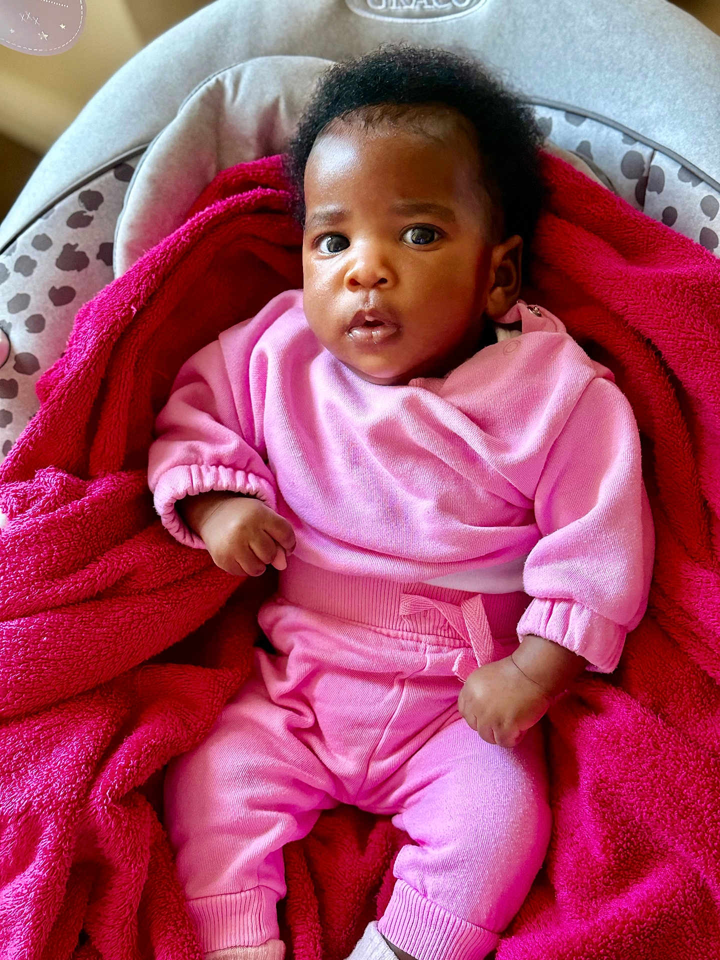 Liat is registered to the contest to win money with this photo: baby, car_seat, child, cozy, curly_hair, cute, fabric, face, gaze, hands, indoor, infant, newborn, pink_blanket, pink_clothing, portrait, sitting, soft_texture, towel, wide_eyes