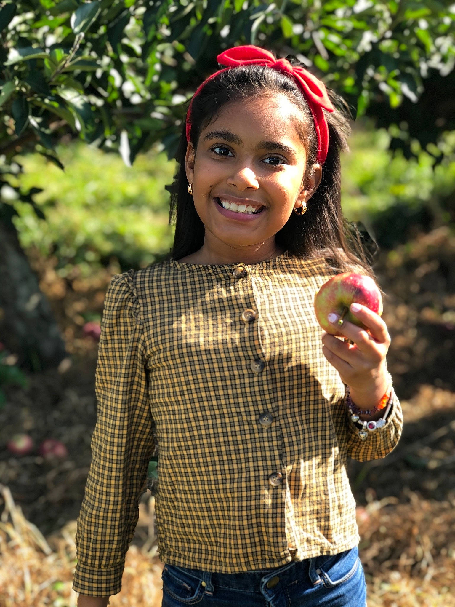 Camilah is registered to the contest to win money with this photo: belt, berry, button, denim, fruit, hair_accessory, hand, headband, headpiece, jeans, joy, natural_foods, people_in_nature, person, plaid, pocket, produce, strawberries, style, tartan