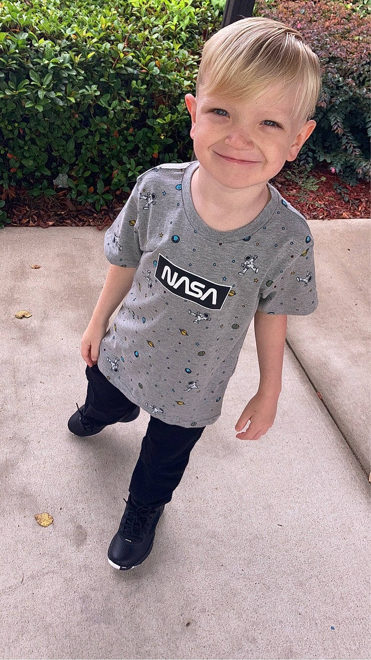 Lincoln is registered to the contest to win money with this photo: baby_toddler_clothing, child, clothing, cool, denim, fun, grass, happy, head, joy, pattern, person, plant, play, sleeve, smile, t_shirt, toddler, top