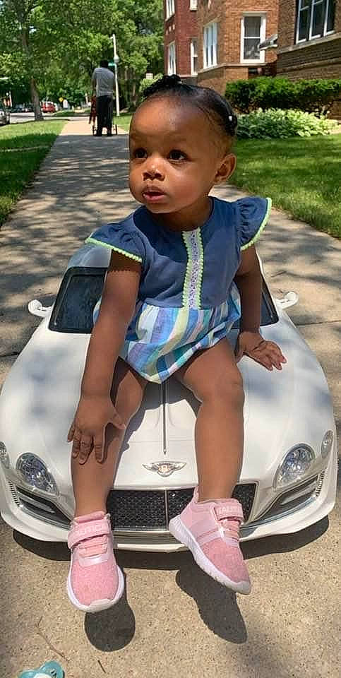 Jeriyah is registered to the contest to win money with this photo: automotive_design, automotive_exterior, automotive_lighting, bumper, car, cool, grass, green, hood, leisure, motor_vehicle, person, photograph, pink, plant, recreation, summer, toddler, vehicle, vehicle_door