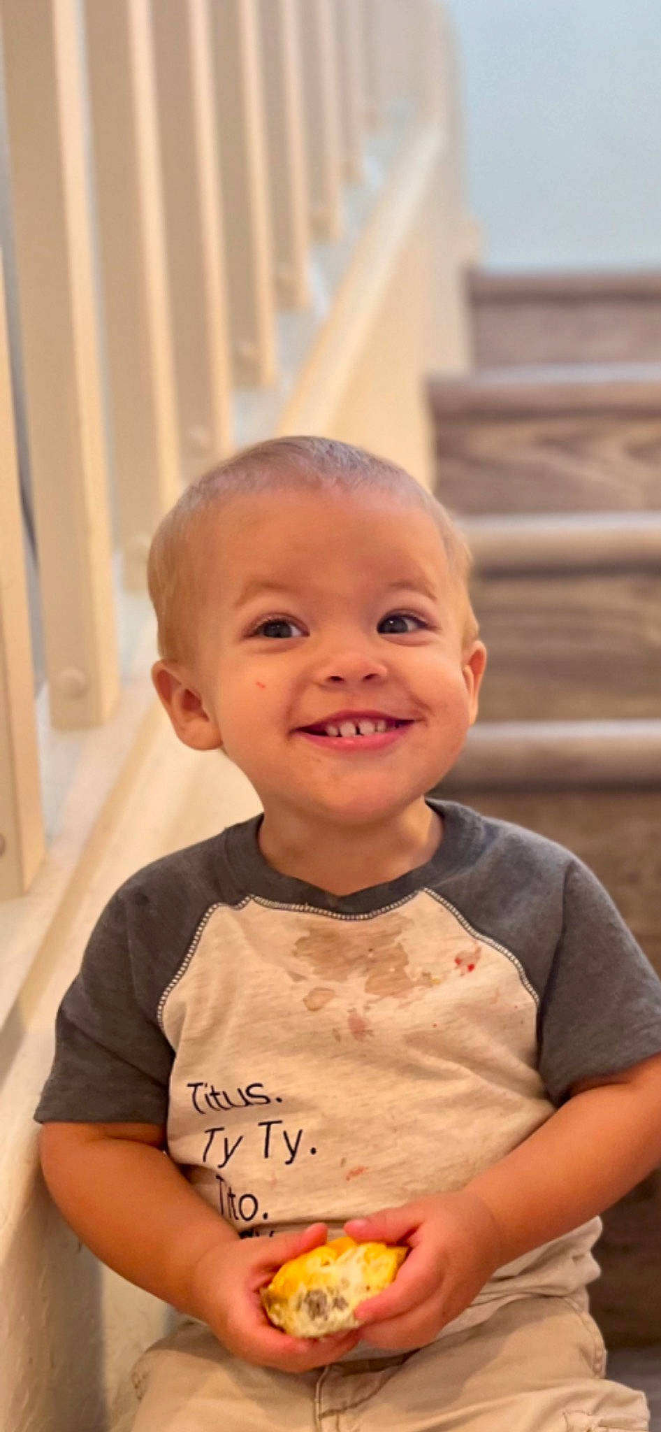 Titus is registered to the contest to win money with this photo: baby, baby_toddler_clothing, cheek, dress, eye, eyebrow, forehead, happy, iris, joy, lip, mouth, neck, nose, person, skin, sleeve, smile, t_shirt, toddler