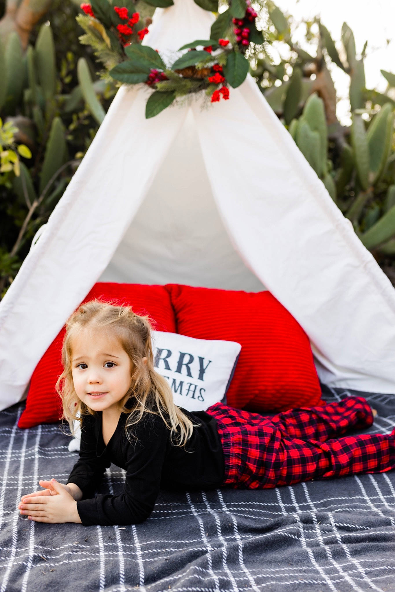 River is registered to the contest to win money with this photo: child, dress, entertainment, event, green, happy, leisure, outerwear, person, petal, plaid, plant, public_space, recreation, red, smile, summer, tartan, textile, toddler