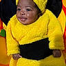 baby, child, costume, bee, yellow, black, plush, smile, cute, infant, playmat, happy, portrait, indoors, soft, warm, clothing, young, face, fun