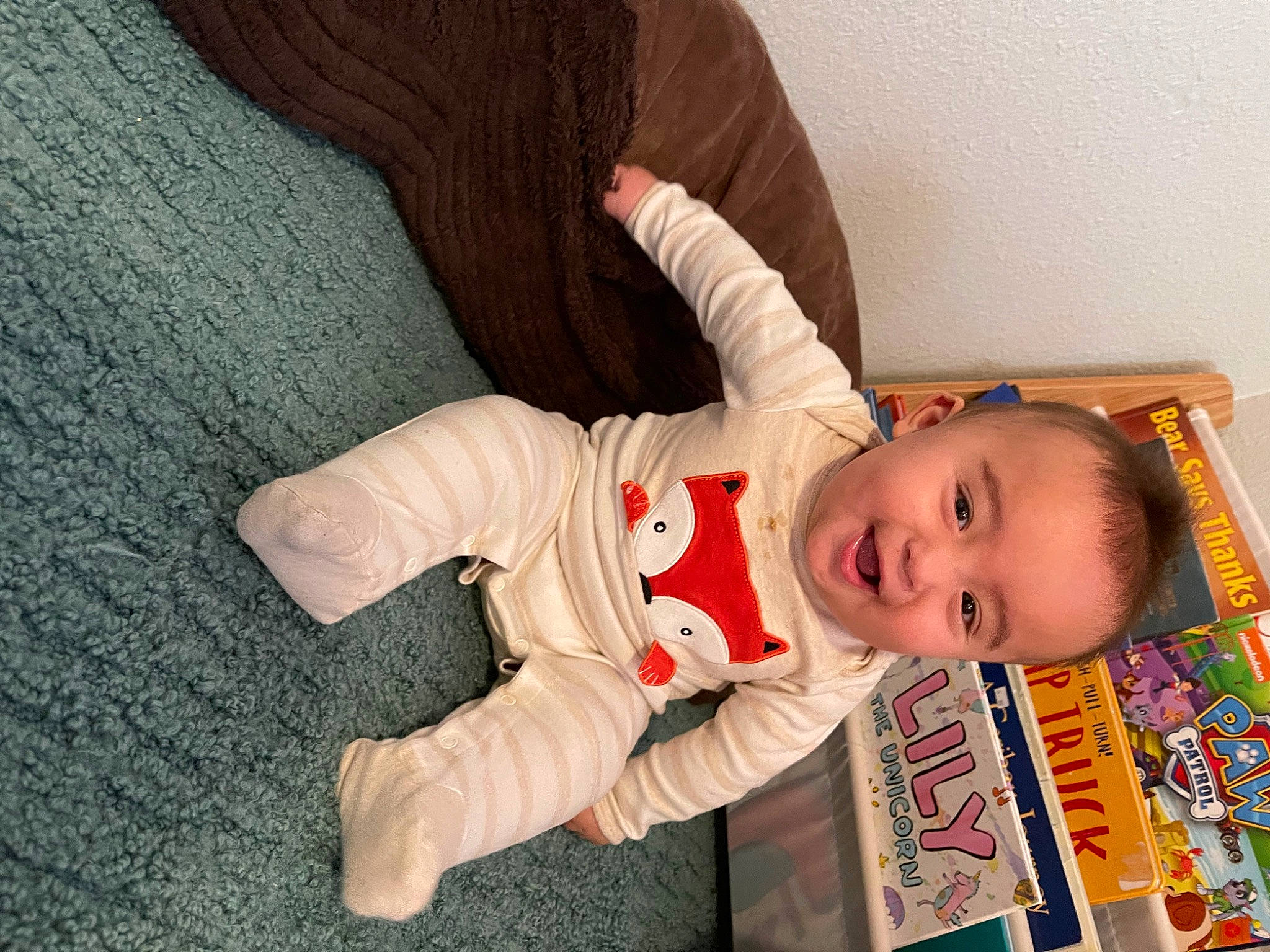 Jamison is registered to the contest to win money with this photo: arm, baby, baby_toddler_clothing, cheek, child, comfort, finger, flooring, fun, hand, happy, human_body, nose, person, room, skin, sleeve, smile, textile, toddler