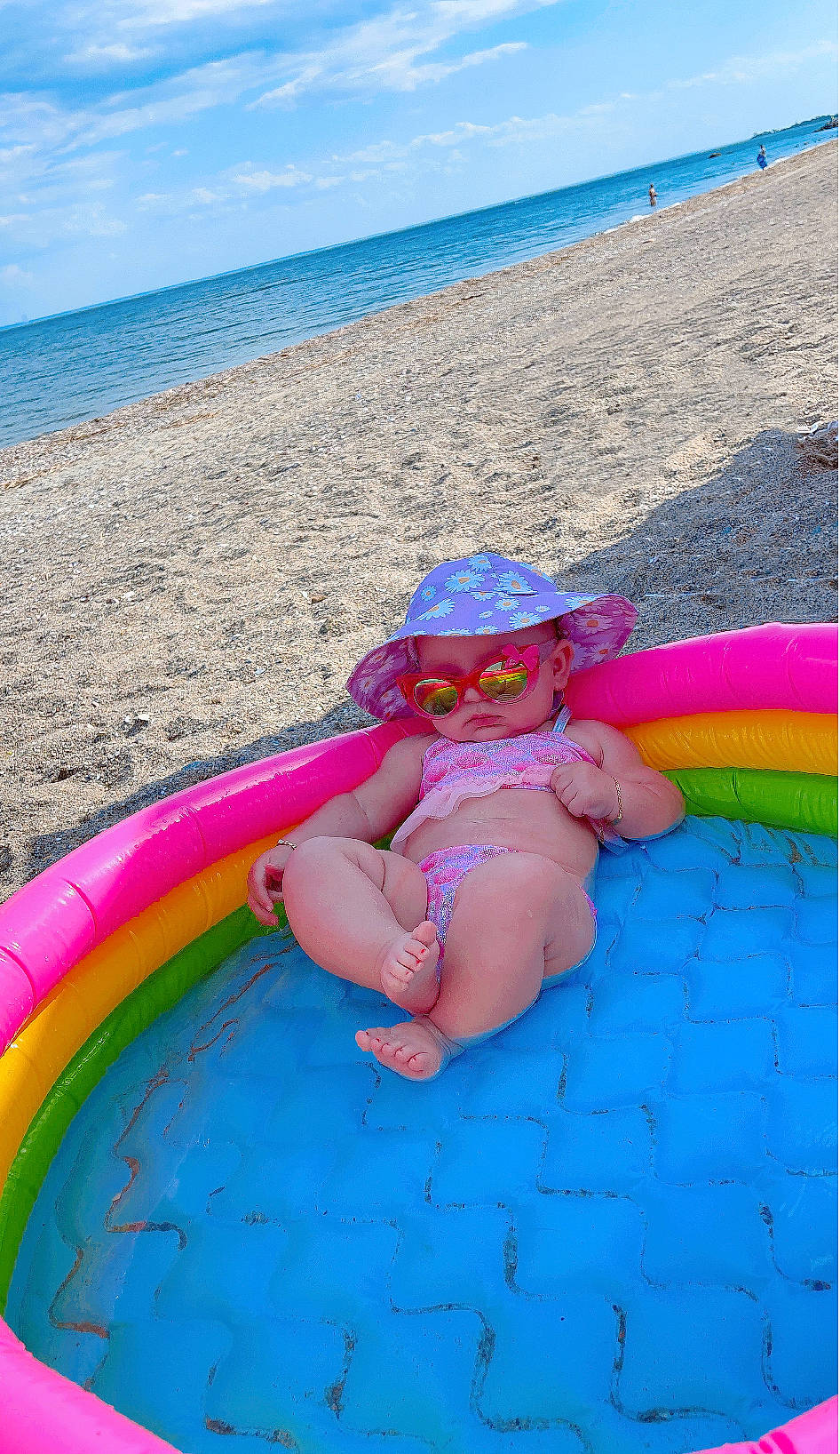 Liana is registered to the contest to win money with this photo: aqua, azure, beach, blue, fun, goggles, human_body, leg, leisure, magenta, outdoor_furniture, people_on_beach, person, pink, recreation, sky, sun_tanning, thigh, toddler, travel
