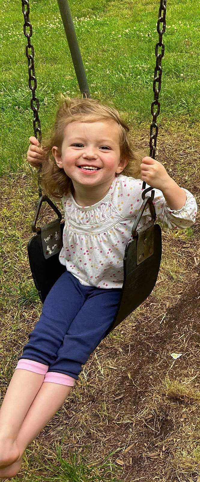 Maddison joined the competition — help win amazing prizes! child, face, facial_expression, fun, grass, green, hairstyle, happy, joy, leaf, leisure, organ, people_in_nature, person, photograph, playground, public_space, smile, standing, swing