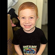 Blake joined the competition — help win amazing prizes! child, boy, smiling, red_hair, tshirt, monster_truck, indoor, portrait, young, happy, face, person, casual_clothing, short_hair, cute, standing, closeup, bright, colorful, background_blur