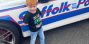 Blake is registered to the contest to win money with this photo: alloywheel, boy, car, carwheel, child, clothing, face, head, jeans, machine, male, pants, person, photography, portrait, spoke, tire, transportation, vehicle, wheel