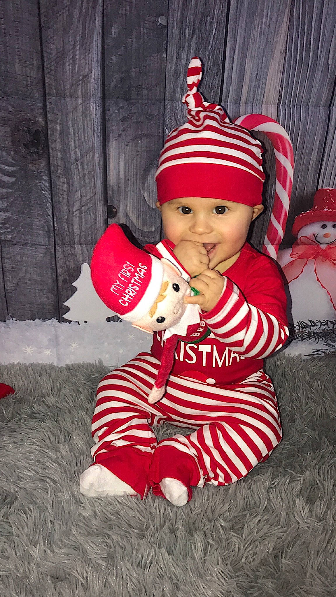 Brayden joined the competition — help win amazing prizes! baby, baby_toddler_clothing, bonnet, child, christmas, christmas_decoration, christmas_eve, costume, costume_accessory, costume_hat, fictional_character, headwear, holiday, human_body, person, pleased, red, stuffed_toy, teddy_bear, toddler