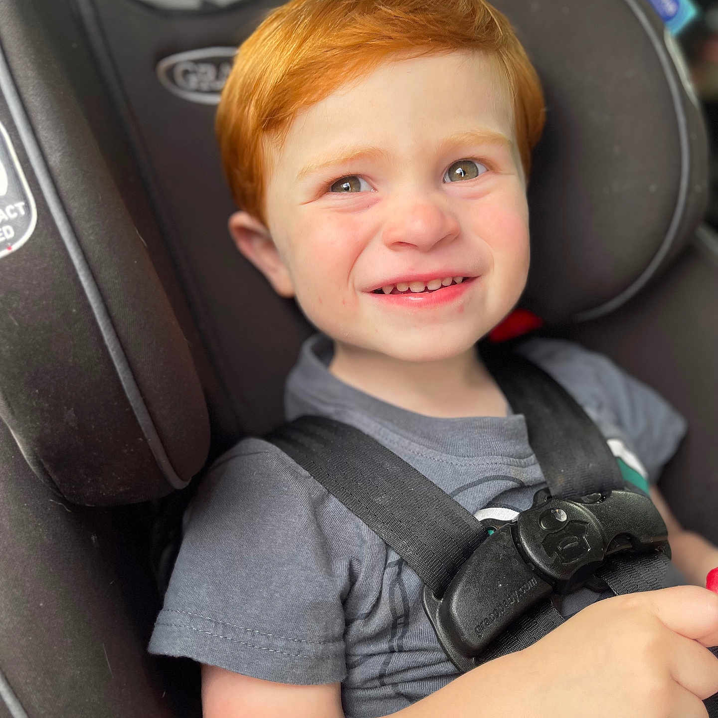 Blake is registered to the contest to win money with this photo: accessories, baby, belt, bodypart, clothing, cushion, face, finger, hand, happy, head, homedecor, pants, person, photography, portrait, smile, t_shirt, transportation, vehicle