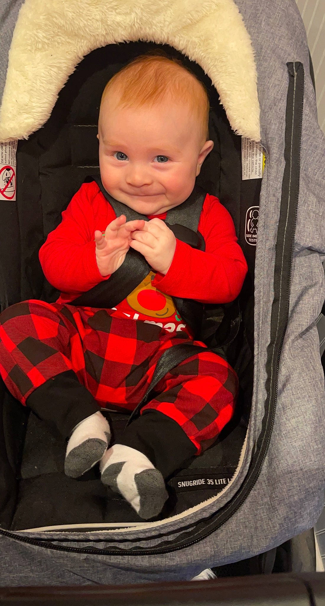 Blake joined the competition — help win amazing prizes! baby, baby_carriage, baby_products, baby_toddler_clothing, bag, black, car_seat, carmine, child, comfort, face, pattern, person, plaid, sitting, sleeve, smile, sock, tartan, textile