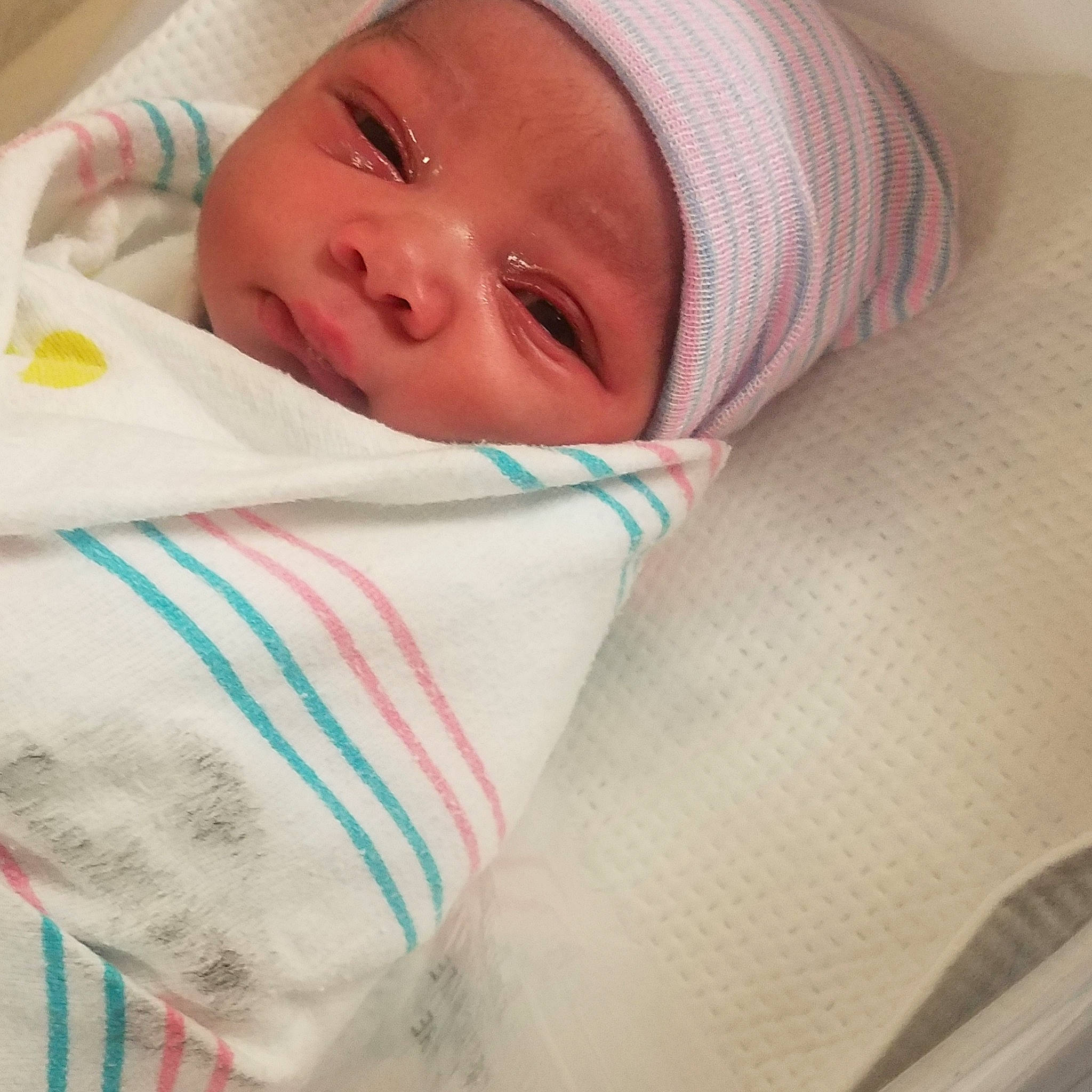 Enrique is registered to the contest to win money with this photo: baby_products, blanket, cheek, child, girl, headwear, infant, linens, lip, material, person, product, skin, smile, textile, toddler