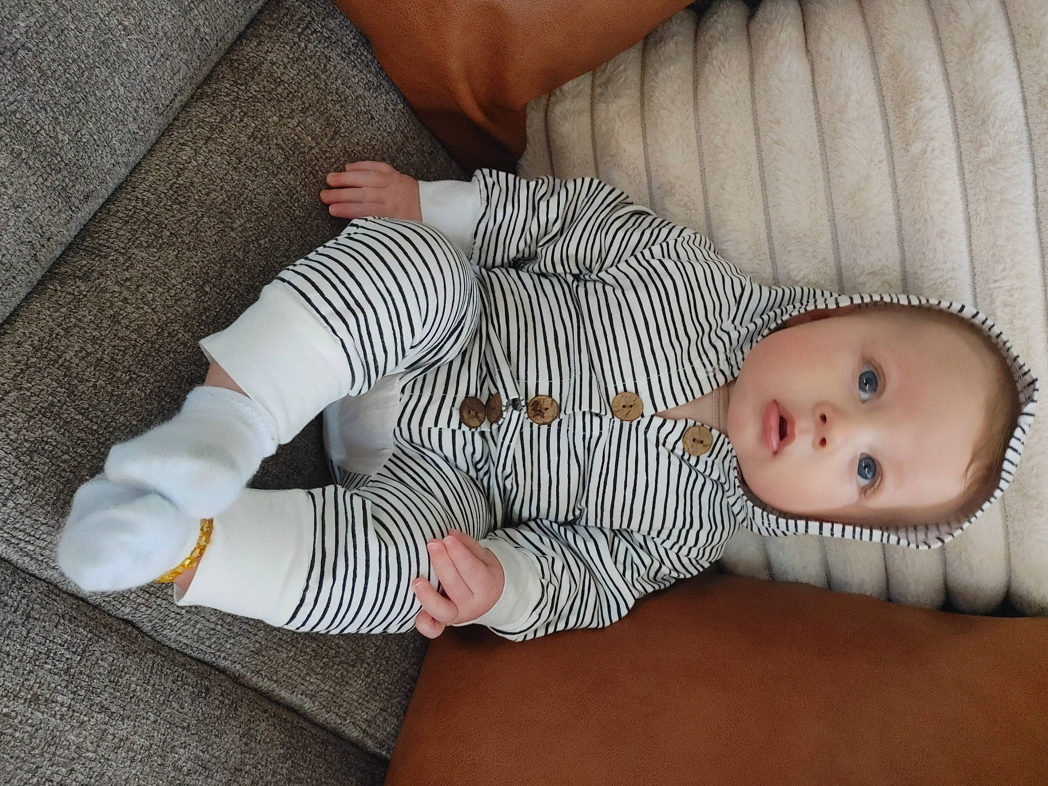 James joined the competition — help win amazing prizes! arm, baby, baby_products, baby_sleeping, baby_toddler_clothing, child, comfort, face, finger, flooring, foot, hand, linens, pattern, person, sitting, skin, sleeve, sock, surprise