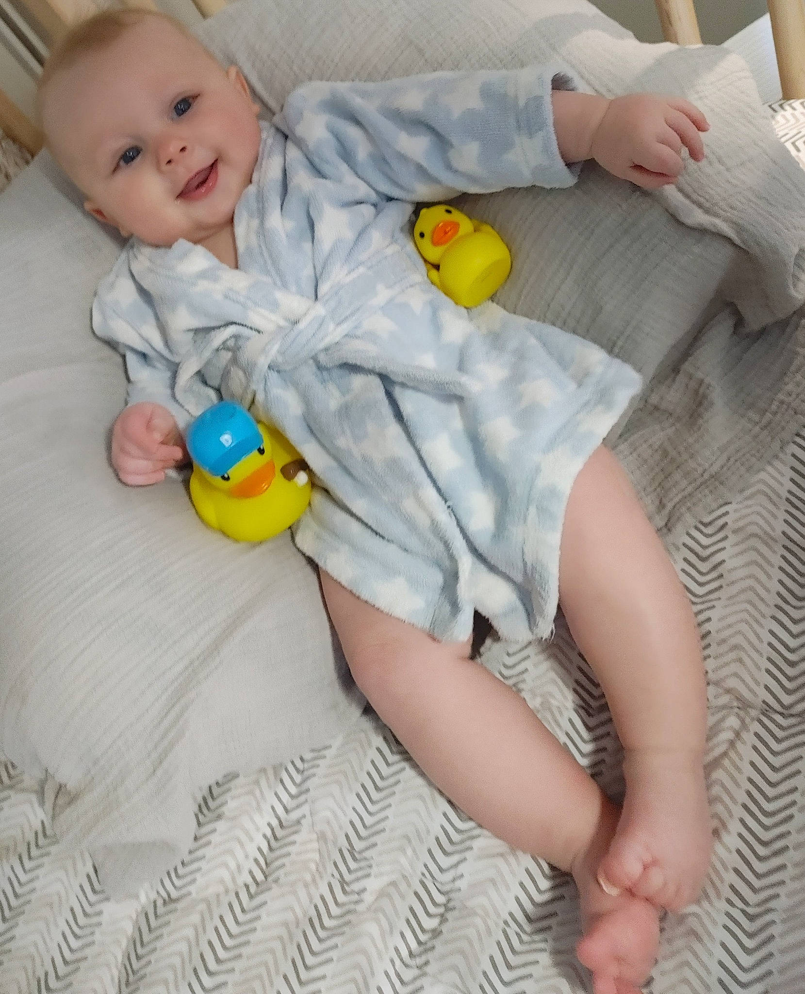 James joined the competition — help win amazing prizes! baby, baby_products, baby_toddler_clothing, child, comfort, flooring, foot, human_leg, joy, knee, linens, orange, pattern, person, room, sitting, skin, sleeve, smile, textile