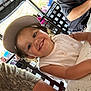 Miley joined the competition — help win amazing prizes! child, toddler, smile, hat, baseball_cap, white_shirt, table, outdoor, restaurant, people, dining, chair, daylight, happy, casual, portrait, food, family, fun, candid