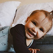 Miley is registered to the contest to win money with this photo: toddler, child, smiling, happy, bed, blanket, pillow, hair, face, clothing, indoor, cute, person, portrait, baby, cozy, comfort, young_child, infant, expression