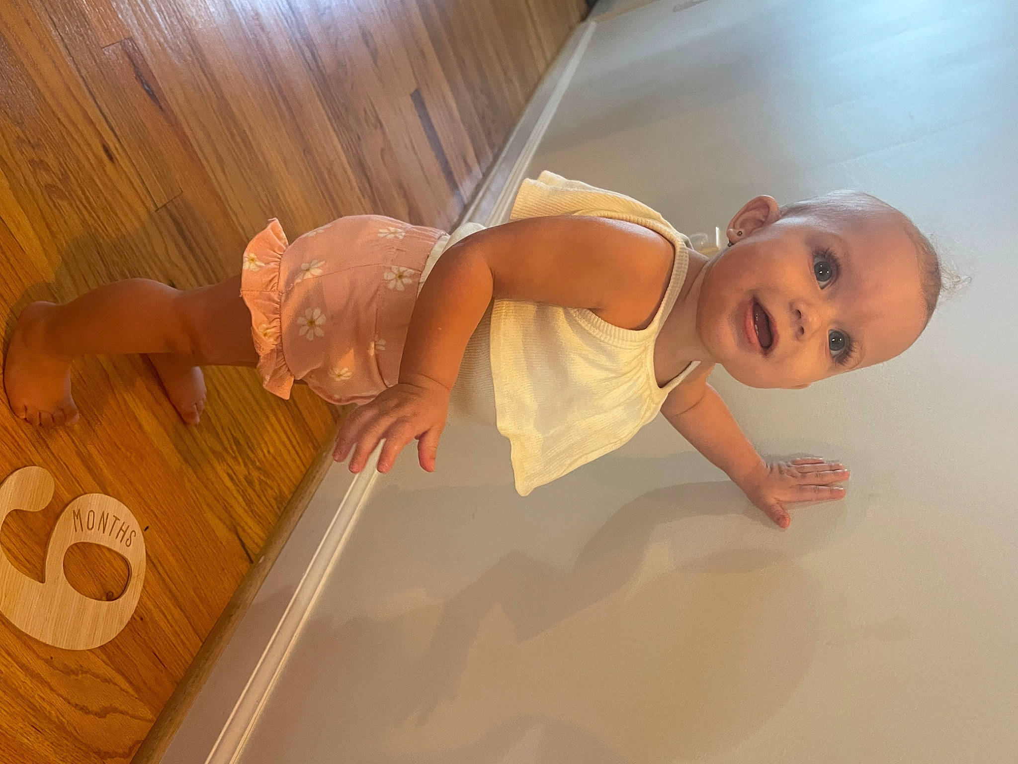 Kinley joined the competition — help win amazing prizes! baby, baby_products, baby_safety, baby_toddler_clothing, bathing, child, comfort, finger, floor, flooring, foot, happy, hardwood, human_leg, person, room, smile, thumb, toddler, varnish