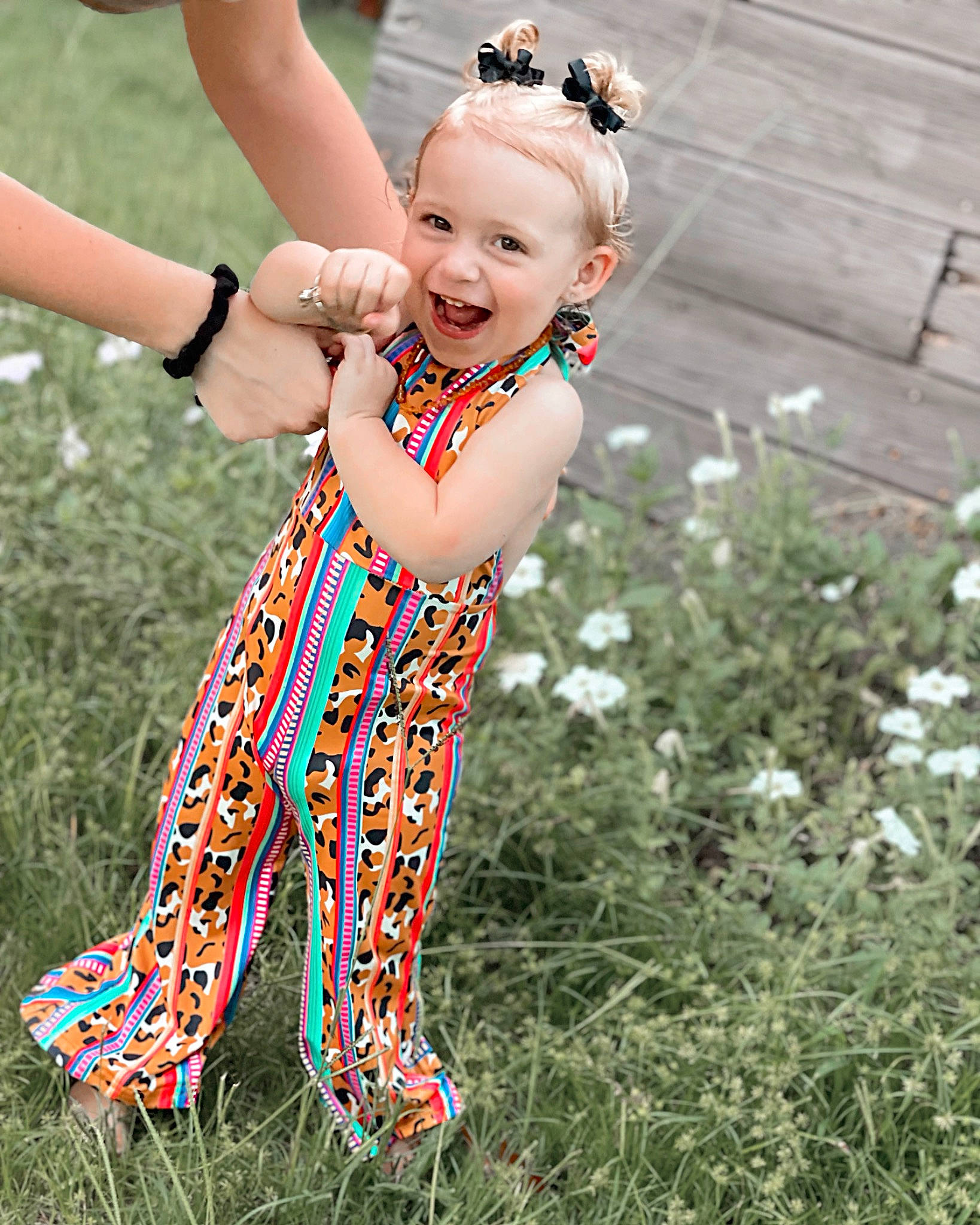 Brayley joined the competition — help win amazing prizes! baby_toddler_clothing, barefoot, child, entertainment, event, flower, gesture, grass, hand, happy, human_leg, jewellery, meadow, pattern, people_in_nature, person, pink, plant, smile, thumb