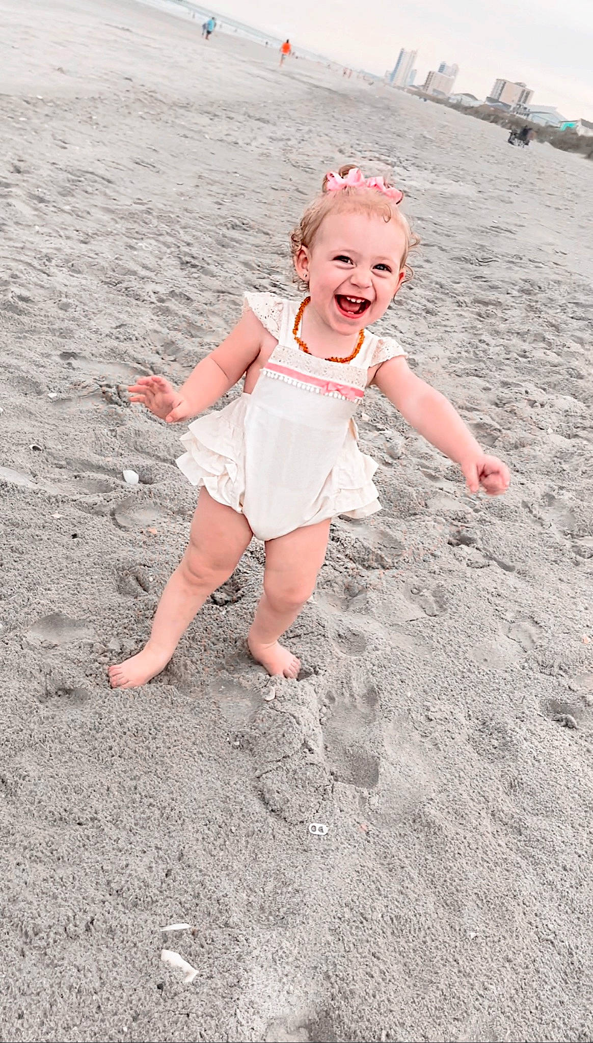 Brayley joined the competition — help win amazing prizes! asphalt, beach, child, finger, fun, gesture, grass, happy, human_leg, joy, landscape, people_in_nature, people_on_beach, person, pink, recreation, road_surface, sand, smile, standing
