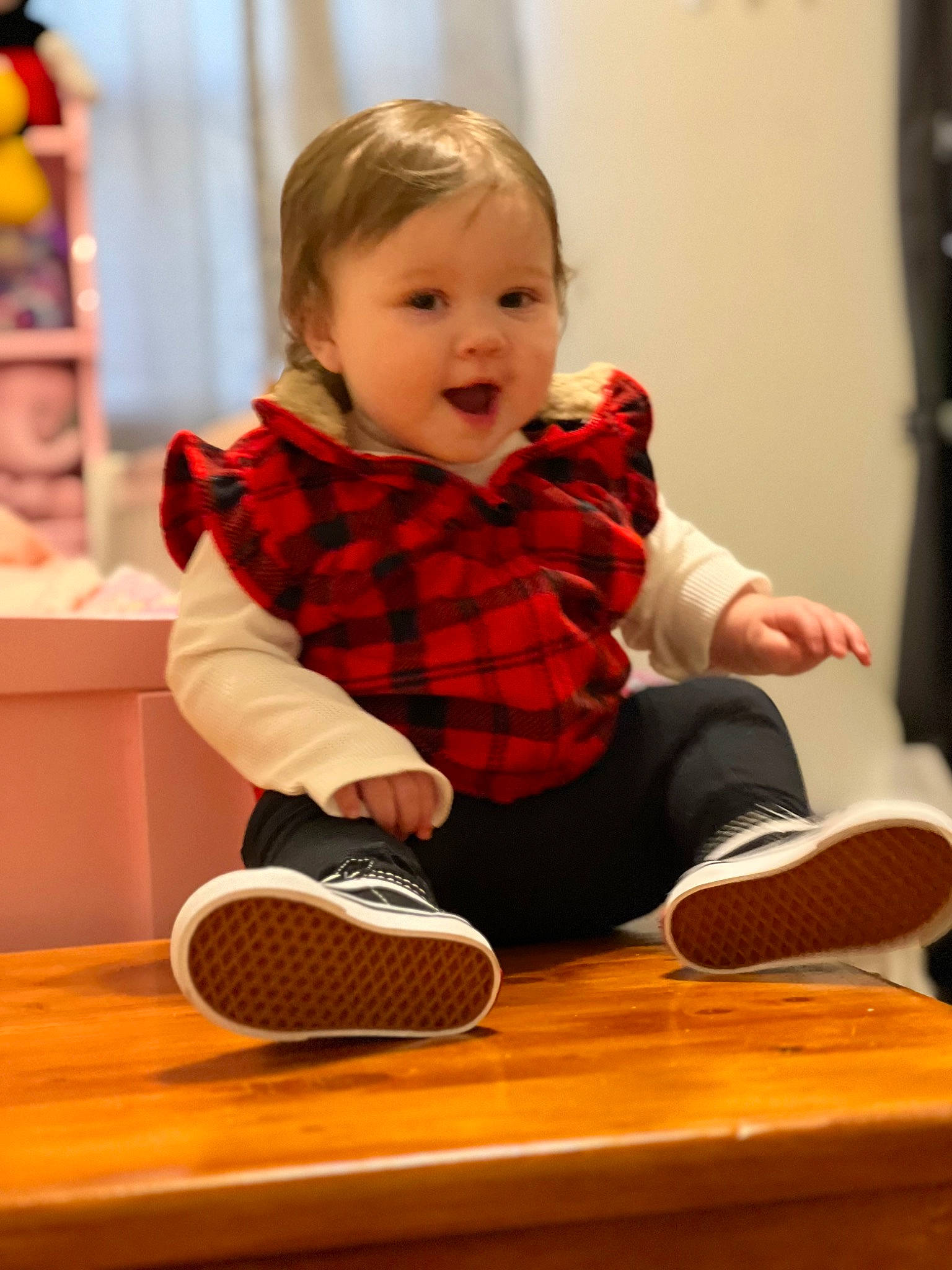 Averie joined the competition — help win amazing prizes! audio_equipment, baby, baby_playing_with_toys, child, comfort, facial_expression, flooring, fun, knee, mammal, person, plaid, sitting, smile, sneakers, sock, standing, table, tartan, toddler