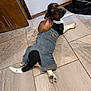 dog, denim, jeans, indoor, tile_floor, pet_bowl, wooden_door, curious, black_and_tan, white_paws, pet, animal, casual, resting, looking_back, floor, cute, domestic, companion, canine