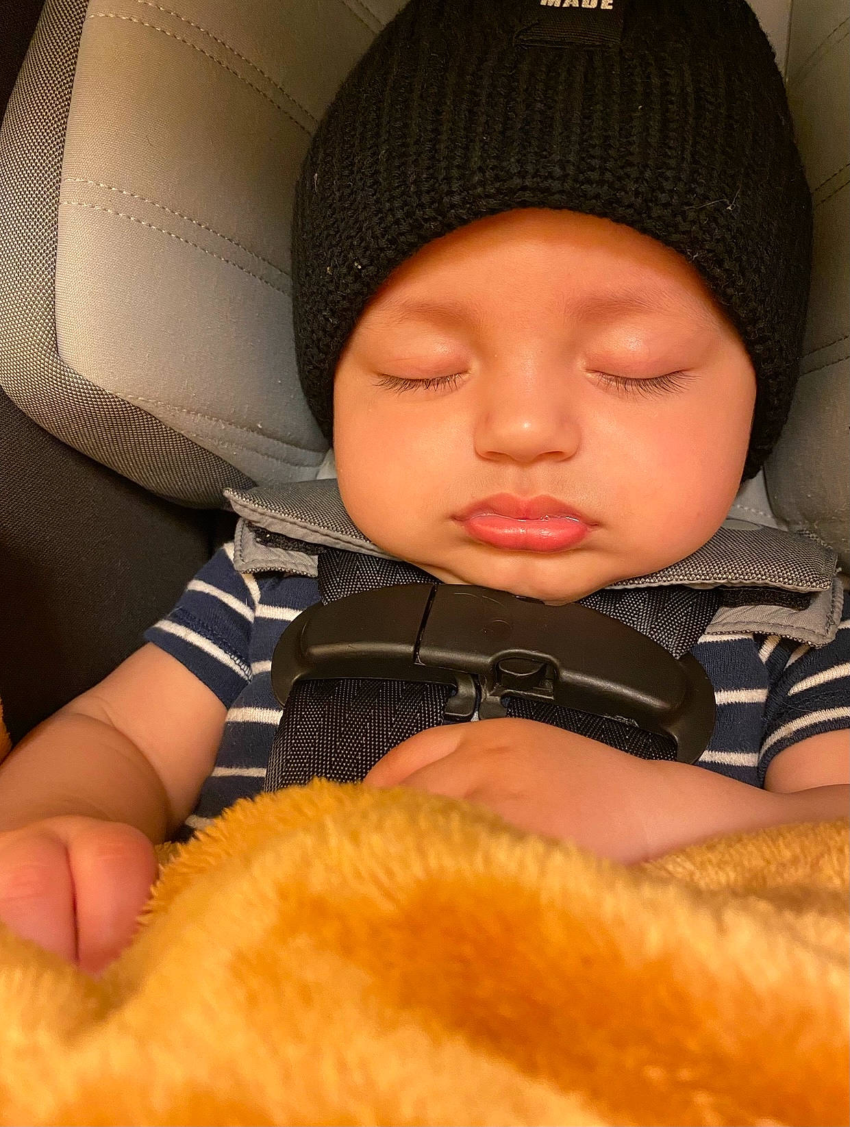 Amani joined the competition — help win amazing prizes! baby, baby_products, baby_sleeping, baby_toddler_clothing, beanie, cap, car_seat, cheek, child, comfort, fashion_accessory, finger, fur, gesture, headwear, knit_cap, person, sitting, skin, sleeve