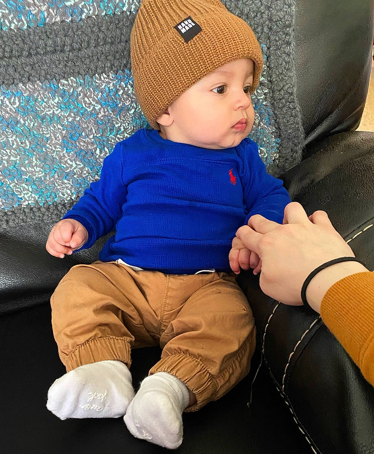 Amani joined the competition — help win amazing prizes! arm, azure, baby, baby_toddler_clothing, beanie, cap, child, clothing, comfort, costume_hat, electric_blue, fashion_accessory, headwear, knit_cap, lap, outerwear, person, product, sitting, sleeve